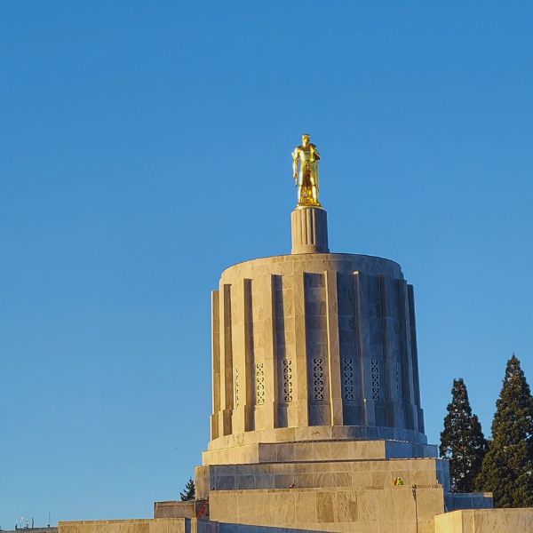 Salem, Oregon capitol building top showing the golden man in the morning light