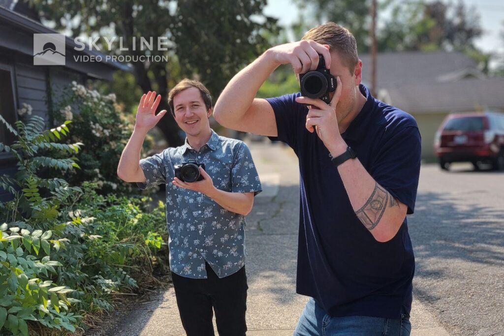 andrew and phillip waving at the camera from a video shoot